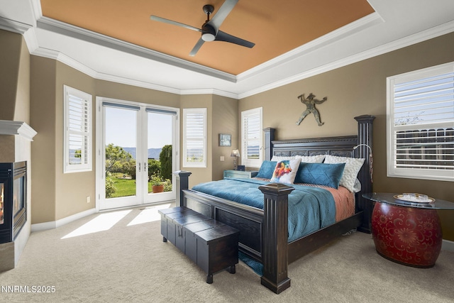 2698 Wind Feather Trl, Reno, NV 89511 - carpeted bedroom featuring a raised ceiling, access to exterior, crown molding, a multi sided fireplace, and french doors