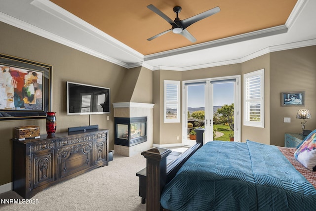 2698 Wind Feather Trl, Reno, NV 89511 - carpeted bedroom featuring access to outside, a raised ceiling, a multi sided fireplace, french doors, and crown molding