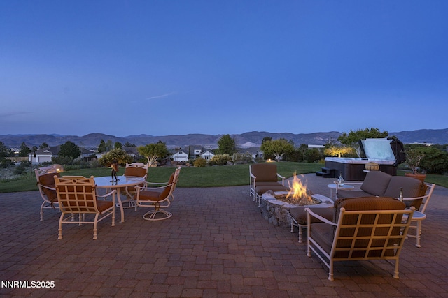 2698 Wind Feather Trl, Reno, NV 89511 - view of patio / terrace featuring a mountain view, a fire pit, and outdoor dining space