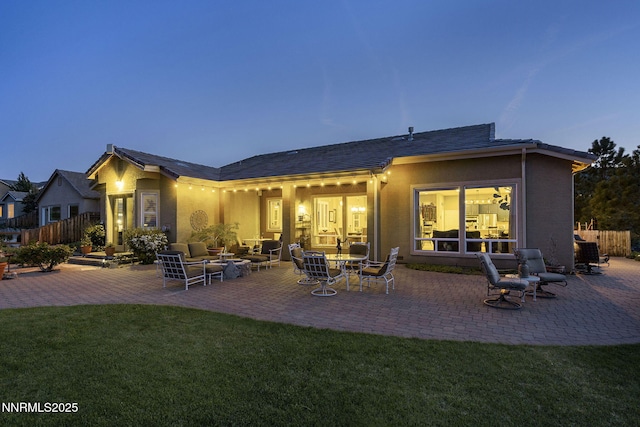 2698 Wind Feather Trl, Reno, NV 89511 - back of property with a patio, stucco siding, and outdoor lounge area