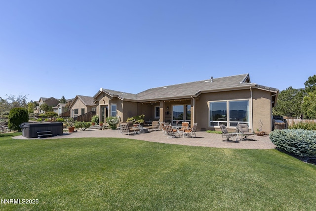 2698 Wind Feather Trl, Reno, NV 89511 - back of property with a hot tub, stucco siding, and a patio area