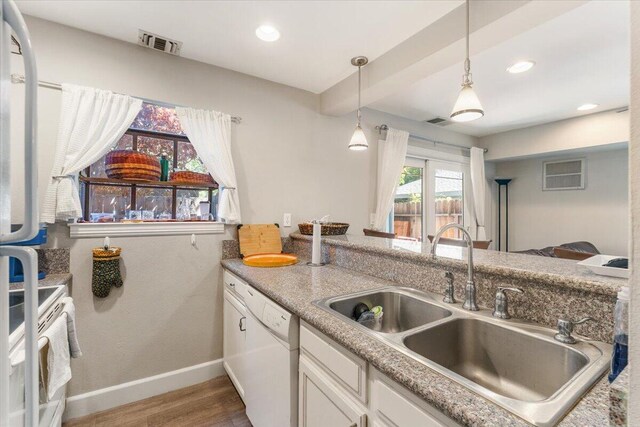 2249 Kietzke Ln Apt C, Reno, NV 89502 - kitchen featuring a sink, white appliances, wood finished floors, baseboards, and white cabinetry