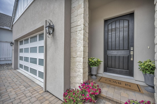 107 Bridlemoor Ct, Reno, NV 89511 - doorway to property with stucco siding and a garage