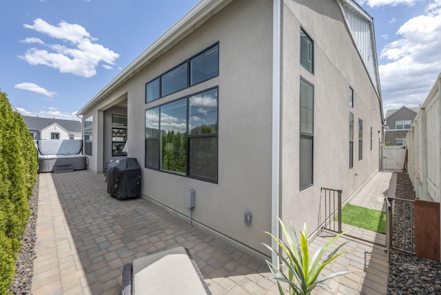107 Bridlemoor Ct, Reno, NV 89511 - view of side of home featuring stucco siding and a patio area
