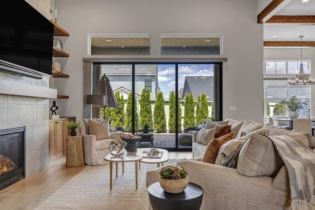 107 Bridlemoor Ct, Reno, NV 89511 - living area featuring a fireplace, beam ceiling, light wood-style floors, and a chandelier