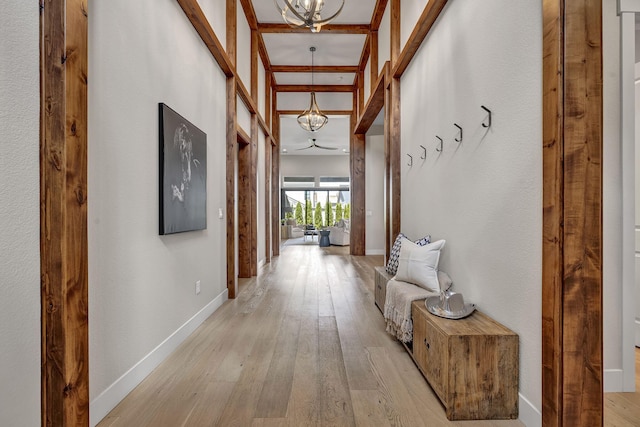 107 Bridlemoor Ct, Reno, NV 89511 - corridor featuring a chandelier, light wood finished floors, and baseboards