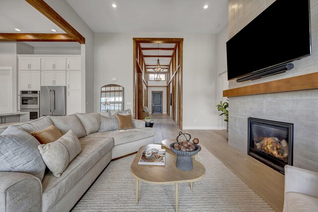 107 Bridlemoor Ct, Reno, NV 89511 - living area with light wood finished floors, recessed lighting, a high ceiling, baseboards, and a fireplace