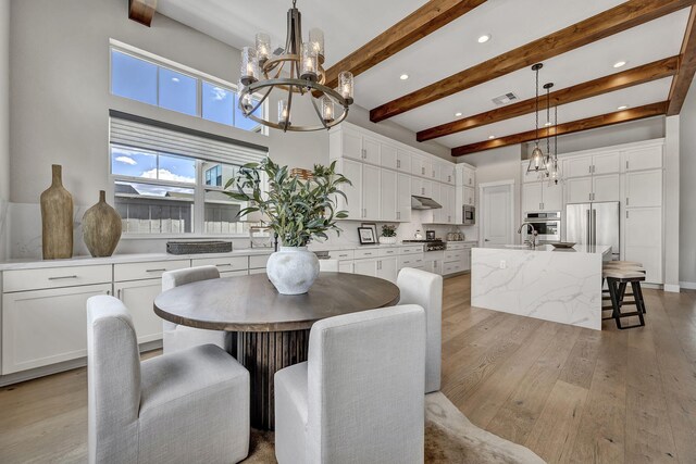 107 Bridlemoor Ct, Reno, NV 89511 - dining space featuring a chandelier, light wood-style flooring, beam ceiling, recessed lighting, and a high ceiling