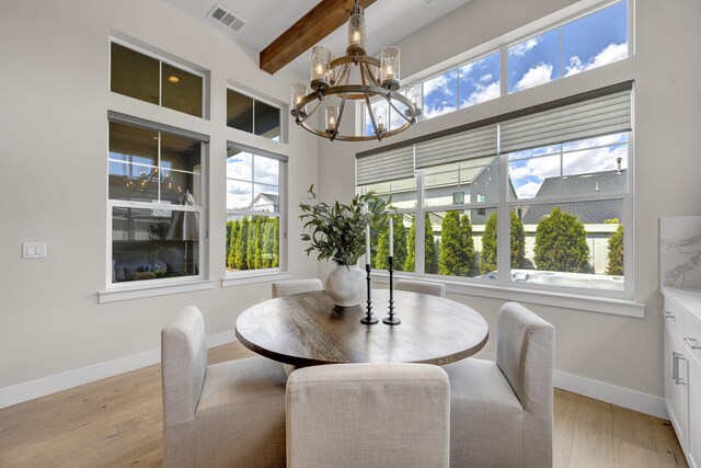107 Bridlemoor Ct, Reno, NV 89511 - dining space with a chandelier, beamed ceiling, baseboards, healthy amount of natural light, and light wood finished floors