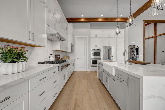 107 Bridlemoor Ct, Reno, NV 89511 - kitchen featuring under cabinet range hood, beamed ceiling, a sink, stainless steel appliances, and light wood-style floors