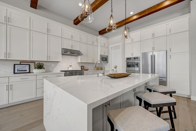 107 Bridlemoor Ct, Reno, NV 89511 - kitchen with beam ceiling, appliances with stainless steel finishes, tasteful backsplash, light wood-style flooring, and white cabinets