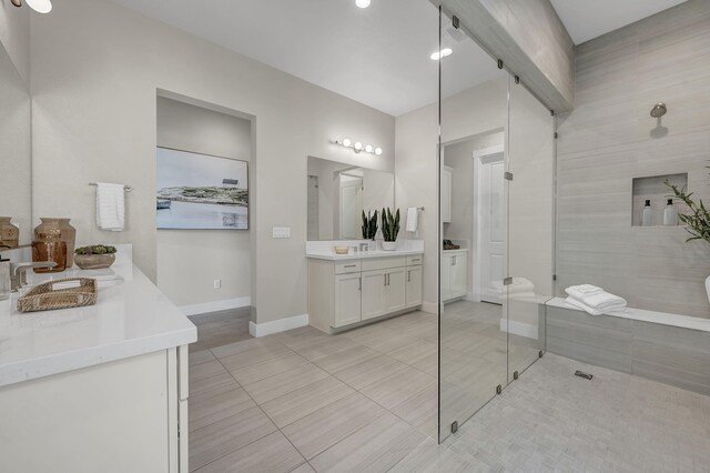107 Bridlemoor Ct, Reno, NV 89511 - bathroom with a tile shower, tile patterned flooring, two vanities, baseboards, and recessed lighting
