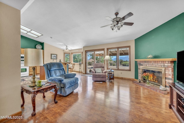 1408 N Santa Barbara Dr, Minden, NV 89423 - living area featuring a ceiling fan, vaulted ceiling, wood finished floors, a brick fireplace, and baseboards