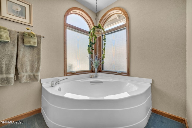 1408 N Santa Barbara Dr, Minden, NV 89423 - bathroom with baseboards, a bath, and a textured wall