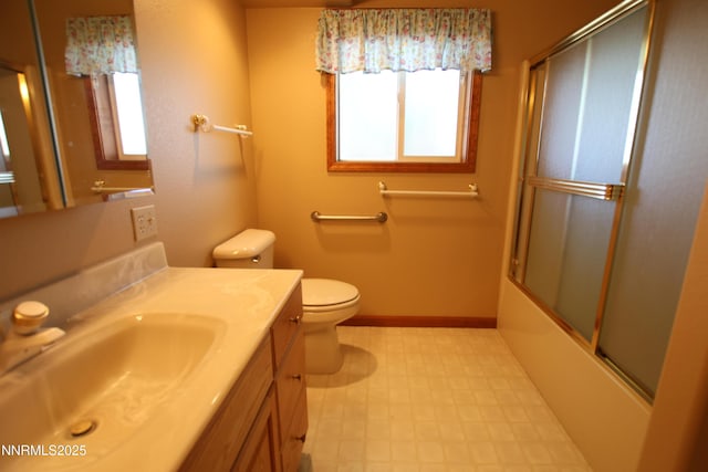 403 Ironwood Ct, Yerington, NV 89447 - bathroom featuring vanity, toilet, tile patterned floors, enclosed tub / shower combo, and baseboards
