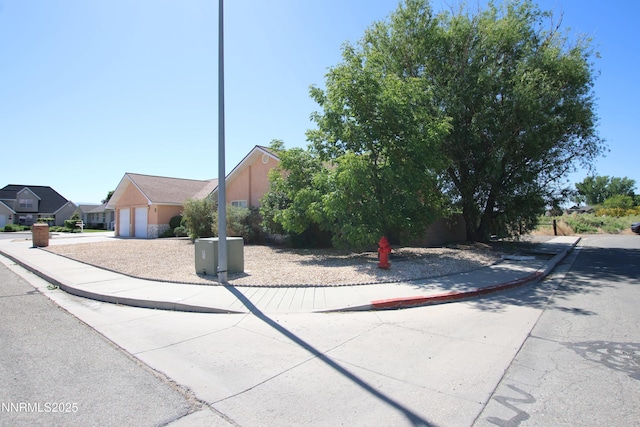 403 Ironwood Ct, Yerington, NV 89447 - obstructed view of property with driveway, stucco siding, and an attached garage
