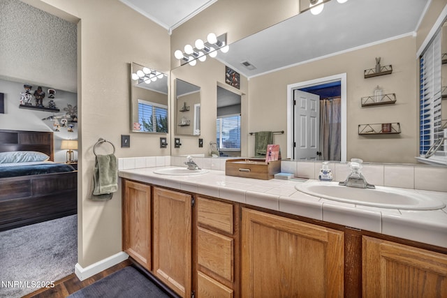 45 Stormy Ct, Sparks, NV 89436 - bathroom featuring ensuite bathroom, crown molding, double vanity, wood finished floors, and baseboards