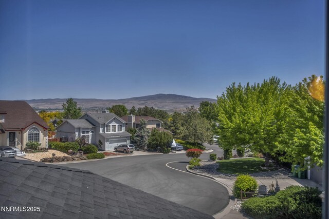 45 Stormy Ct, Sparks, NV 89436 - view of asphalt road with a mountain view, a residential view, and curbs