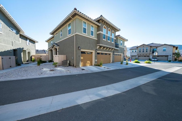 1855 Dark Horse Rd Unit B, Reno, NV 89521 - view of front of home featuring a garage, a residential view, central air condition unit, stucco siding, and driveway