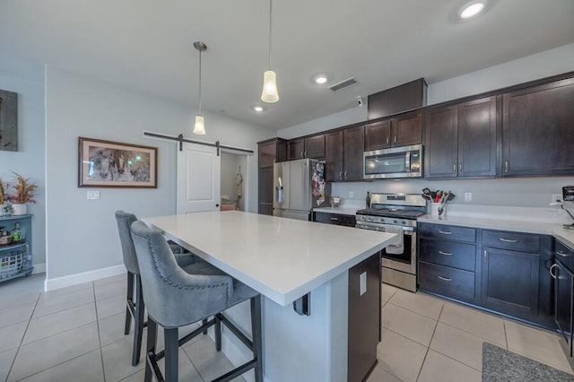 1855 Dark Horse Rd Unit B, Reno, NV 89521 - kitchen with stainless steel appliances, a barn door, light tile patterned flooring, a kitchen island, and recessed lighting