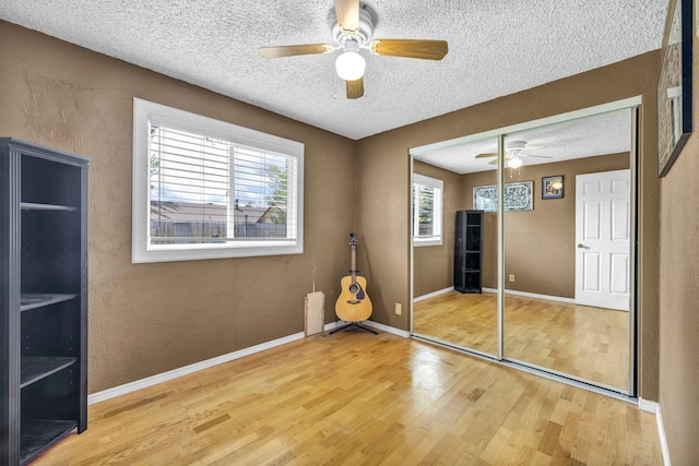3760 Brant St, Reno, NV 89508 - unfurnished bedroom featuring wood finished floors, a textured ceiling, a closet, baseboards, and a ceiling fan