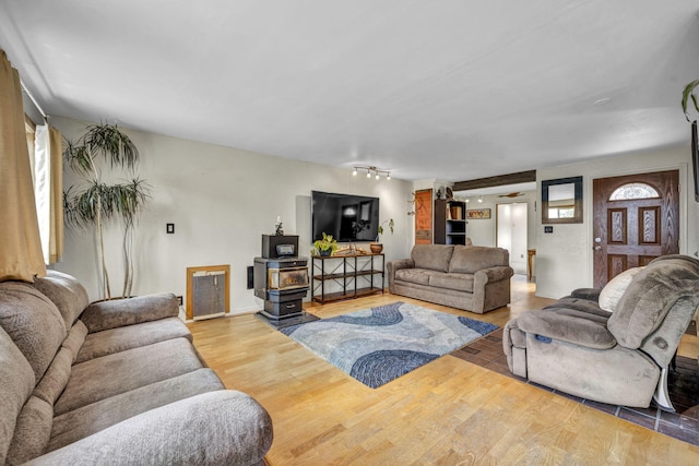 3760 Brant St, Reno, NV 89508 - living area featuring wood finished floors, a wood stove, and healthy amount of natural light