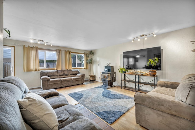 3760 Brant St, Reno, NV 89508 - living room featuring rail lighting, a wood stove, and wood finished floors