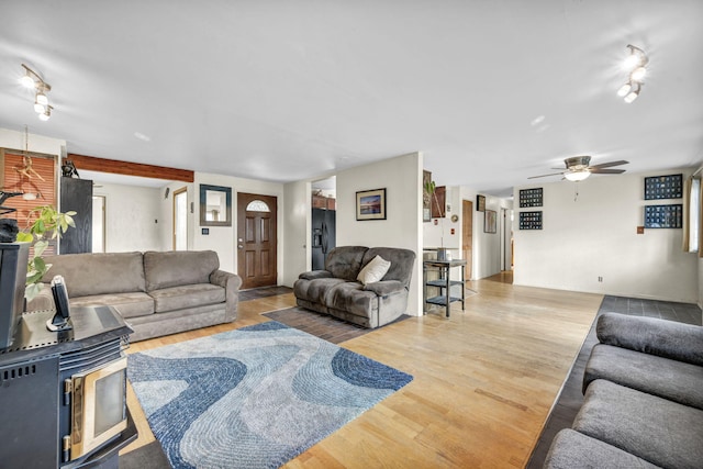 3760 Brant St, Reno, NV 89508 - living area with a ceiling fan, a wood stove, and light wood finished floors