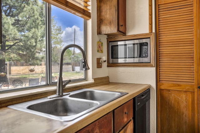 3760 Brant St, Reno, NV 89508 - kitchen featuring stainless steel microwave, black dishwasher, and a sink