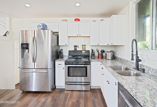 435 Ardmore Dr, Reno, NV 89509 - kitchen with stainless steel appliances, a sink, white cabinets, light stone counters, and recessed lighting