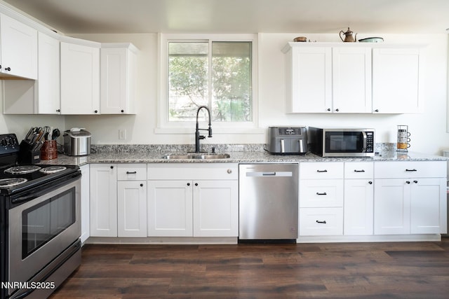435 Ardmore Dr, Reno, NV 89509 - kitchen with stainless steel appliances, a sink, white cabinetry, and light stone counters