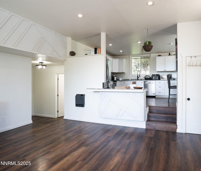 435 Ardmore Dr, Reno, NV 89509 - kitchen with stainless steel appliances, a peninsula, dark wood finished floors, white cabinetry, and recessed lighting