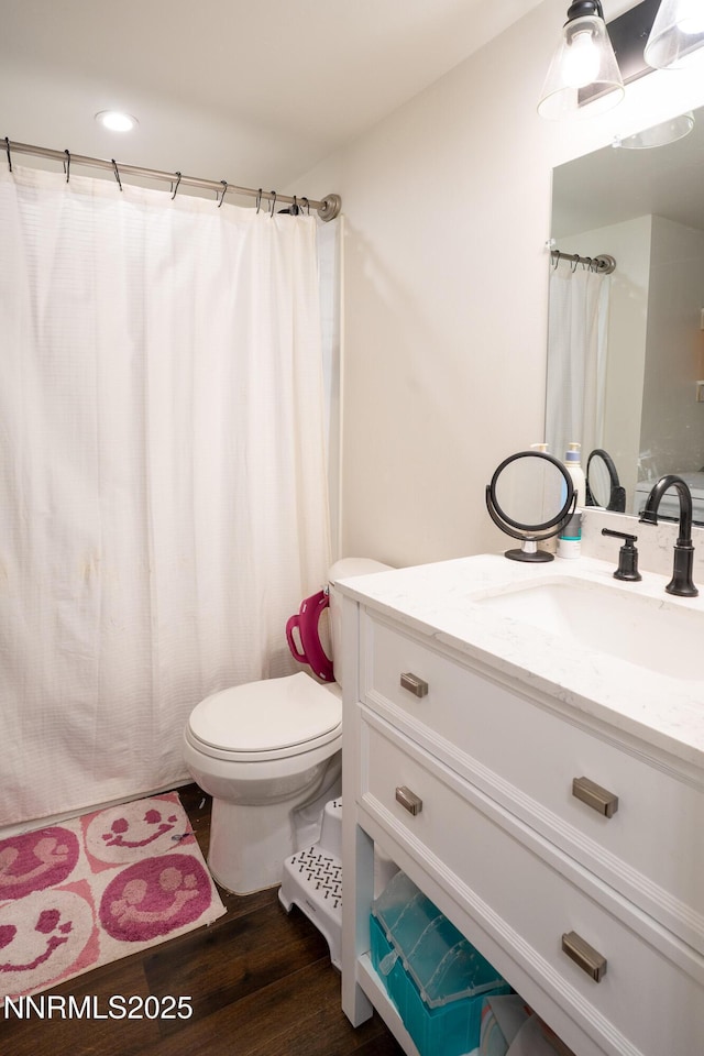 435 Ardmore Dr, Reno, NV 89509 - full bathroom with vanity, wood finished floors, toilet, and a shower with curtain