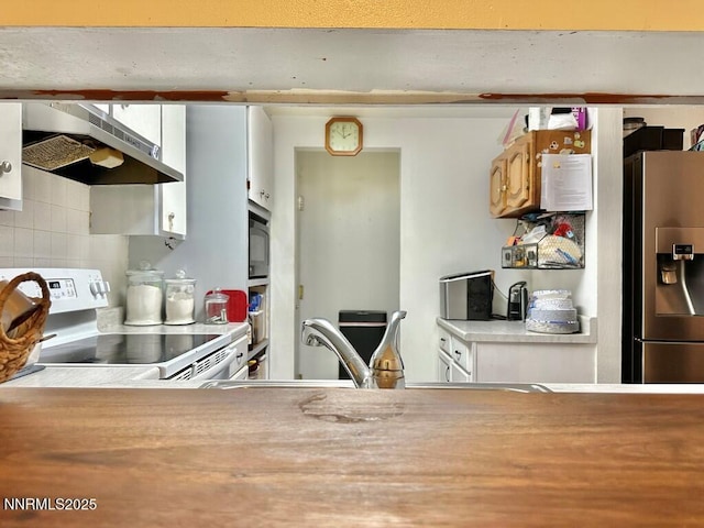 1714 Meadowvale Way, Sparks, NV 89431 - kitchen featuring stainless steel appliances, range hood, tasteful backsplash, light countertops, and white cabinets