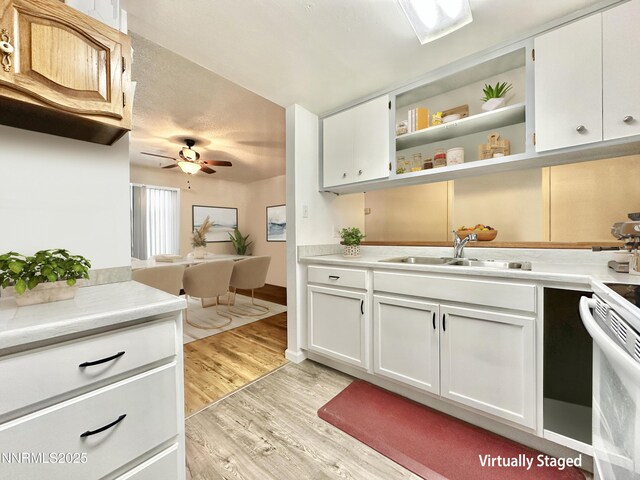 1714 Meadowvale Way, Sparks, NV 89431 - kitchen with a sink, white electric stove, light wood finished floors, and light countertops