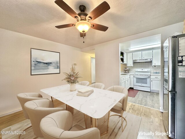 1714 Meadowvale Way, Sparks, NV 89431 - dining area featuring light wood finished floors, a textured ceiling, a ceiling fan, and baseboards