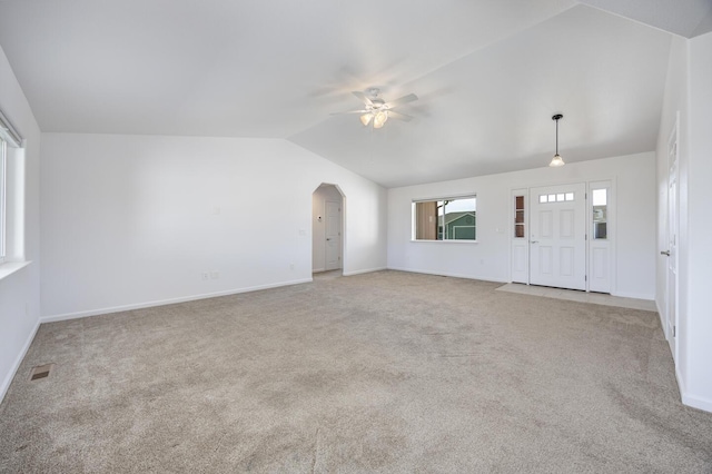 772 Megan Way, Fallon, NV 89406 - unfurnished living room with vaulted ceiling, a ceiling fan, carpet, arched walkways, and baseboards