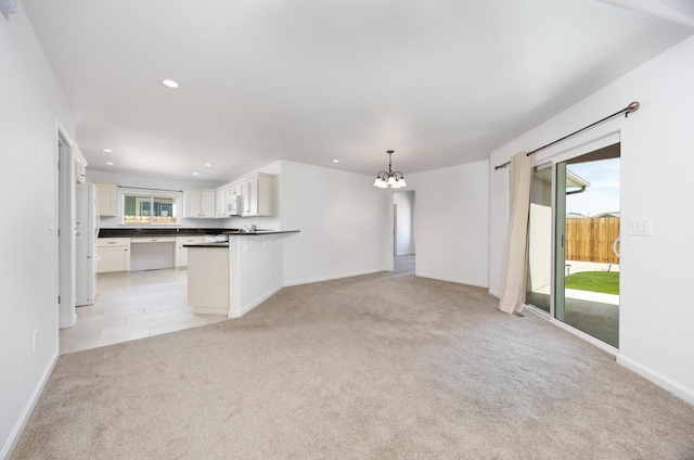 772 Megan Way, Fallon, NV 89406 - unfurnished living room featuring light carpet, a chandelier, recessed lighting, and baseboards