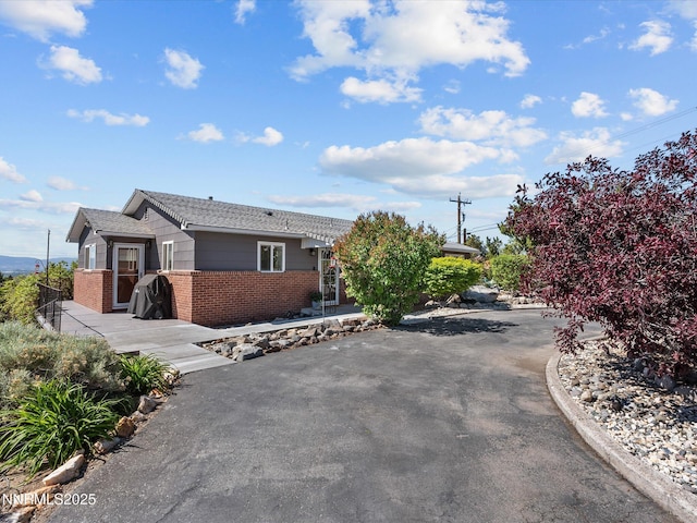 60 Redstone Dr, Reno, NV 89512 - view of front of property with brick siding, driveway, and a patio