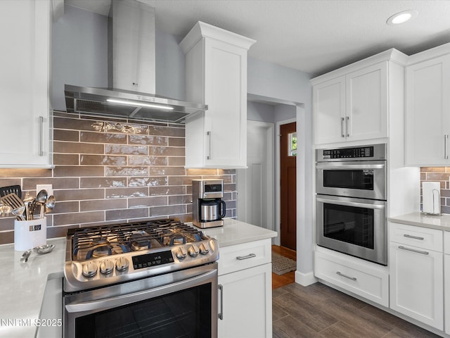 60 Redstone Dr, Reno, NV 89512 - kitchen with wall chimney exhaust hood, stainless steel appliances, decorative backsplash, light countertops, and white cabinetry