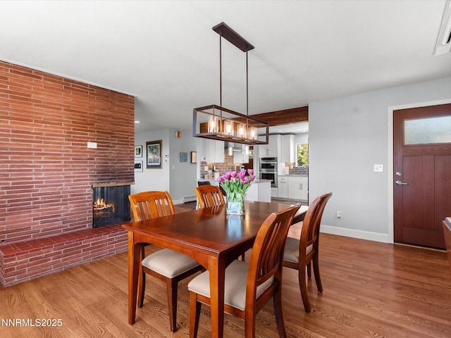 60 Redstone Dr, Reno, NV 89512 - dining space featuring a fireplace, light wood-type flooring, and baseboards