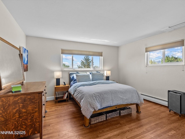 60 Redstone Dr, Reno, NV 89512 - bedroom featuring a baseboard radiator, multiple windows, light wood-type flooring, and baseboards