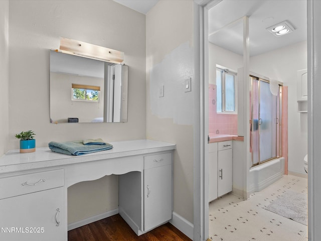 60 Redstone Dr, Reno, NV 89512 - full bathroom featuring vanity, combined bath / shower with glass door, baseboards, and toilet