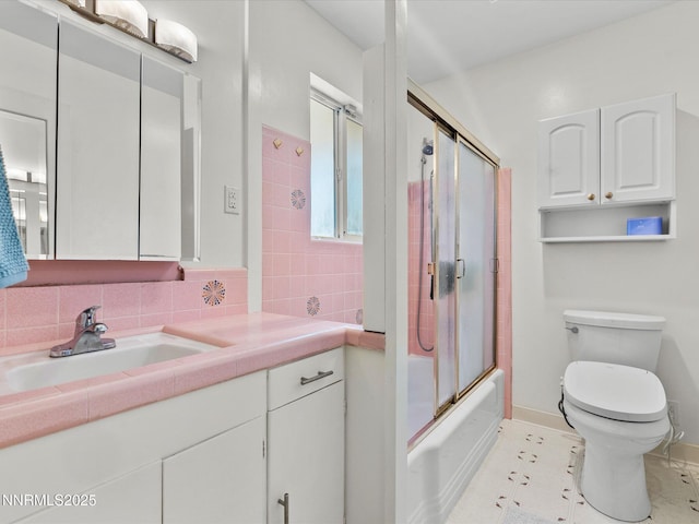 60 Redstone Dr, Reno, NV 89512 - bathroom with toilet, vanity, backsplash, bath / shower combo with glass door, and baseboards