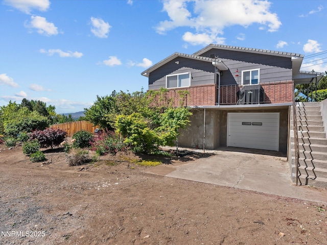 60 Redstone Dr, Reno, NV 89512 - view of front of home with driveway, brick siding, a balcony, and an attached garage