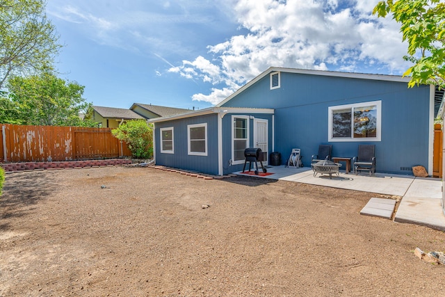7921 Mariner Cove Dr, Reno, NV 89506 - rear view of house with a patio, fence, and a fire pit