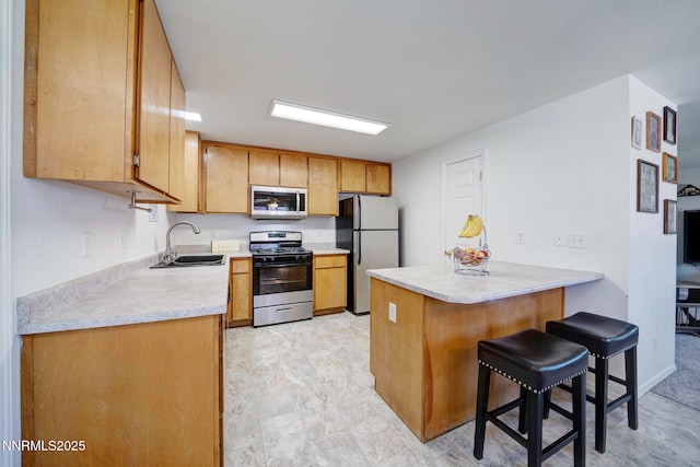 636 Aja Pl, Dayton, NV 89403 - kitchen featuring stainless steel appliances, a sink, a peninsula, light countertops, and a breakfast bar