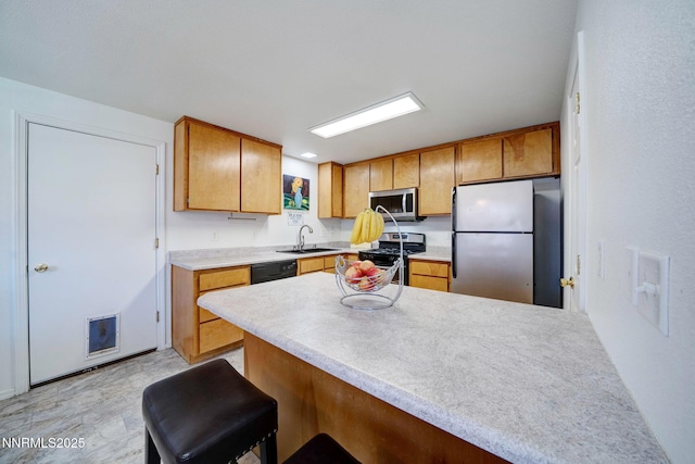 636 Aja Pl, Dayton, NV 89403 - kitchen featuring stainless steel appliances, a peninsula, a sink, light countertops, and brown cabinetry