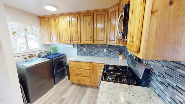 1615 Ballard Ln, Winnemucca, NV 89445 - washroom with light wood finished floors and washing machine and dryer