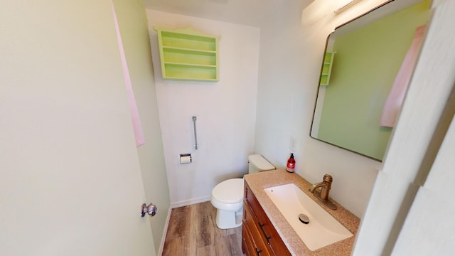 1615 Ballard Ln, Winnemucca, NV 89445 - bathroom featuring toilet, wood finished floors, and vanity